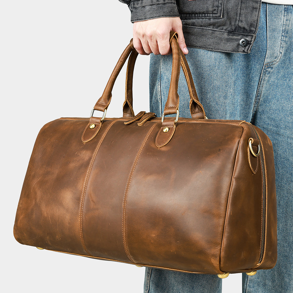 Coffee leather travel duffel, handheld front three-quarter view