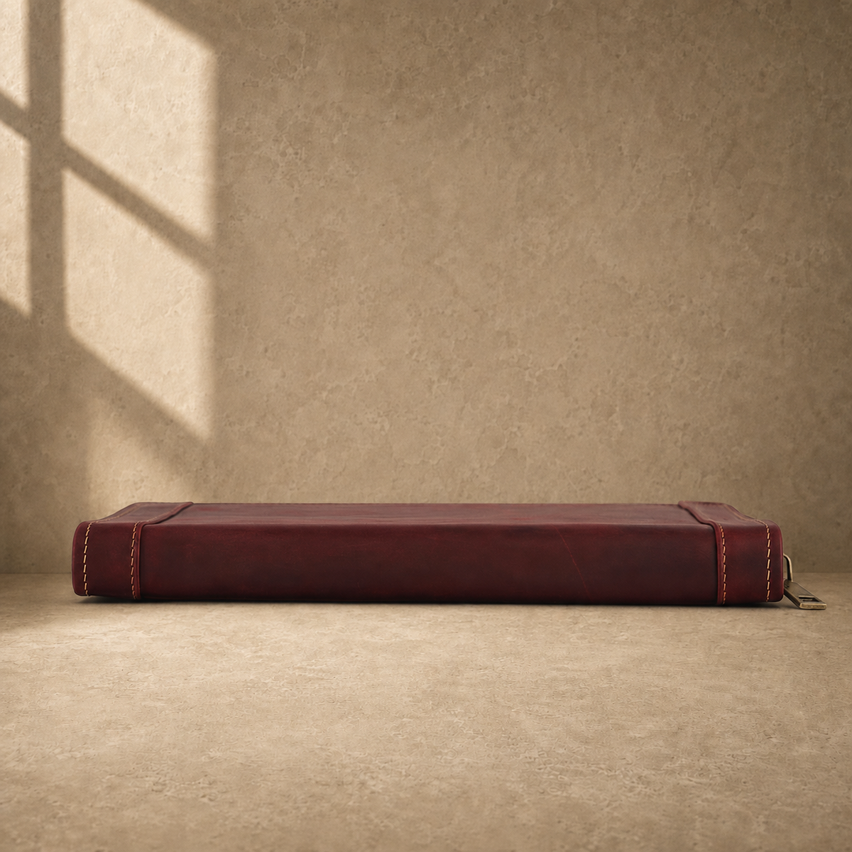 Oxblood leather zip travel portfolio base edge view