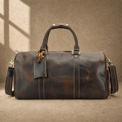 Deep coffee cowhide weekender duffle, front hero view with luggage tag