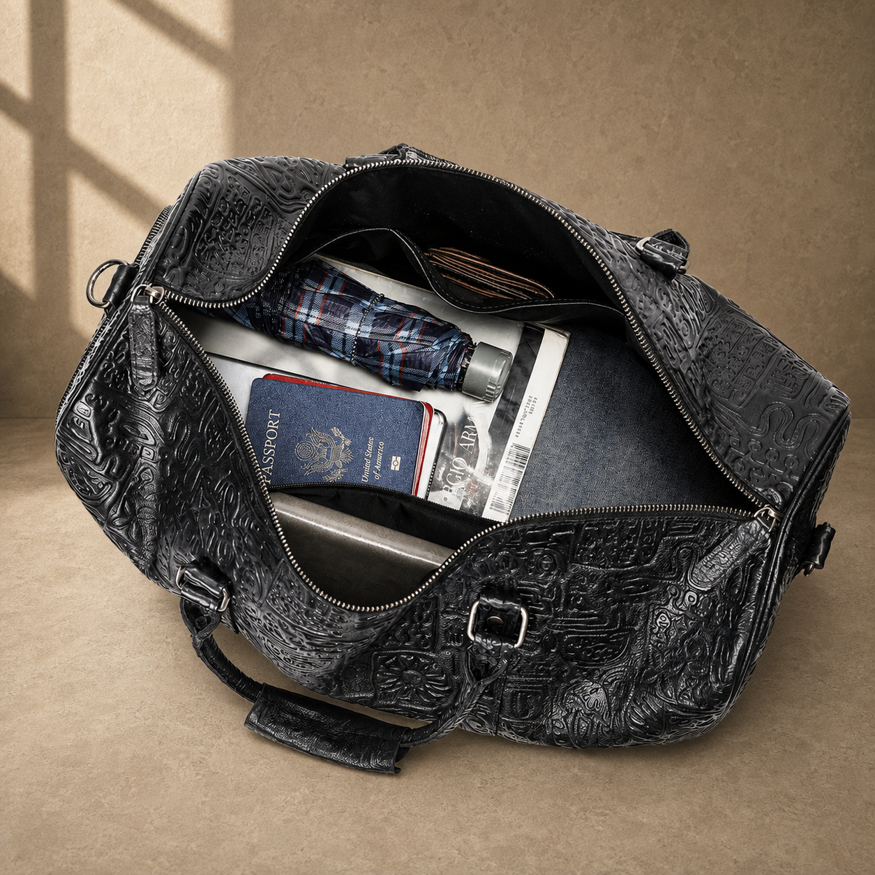 Black embossed leather travel duffel, open packed interior view