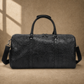 Black embossed leather travel duffel, straight front hero view