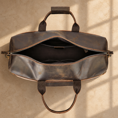 Dark brown cowhide travel duffel bag, open empty interior view