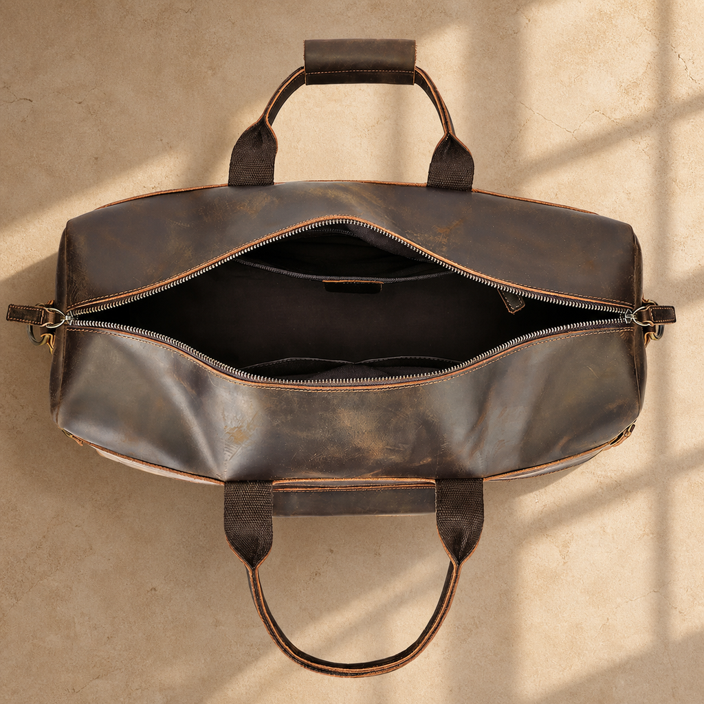 Dark brown cowhide travel duffel bag, open empty interior view