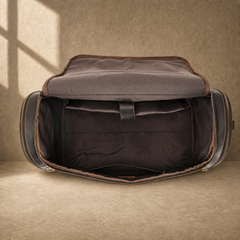 Dark brown leather travel duffel bag, open empty main compartment