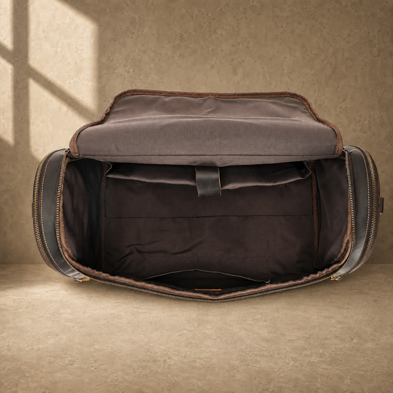 Dark brown leather travel duffel bag, open empty main compartment