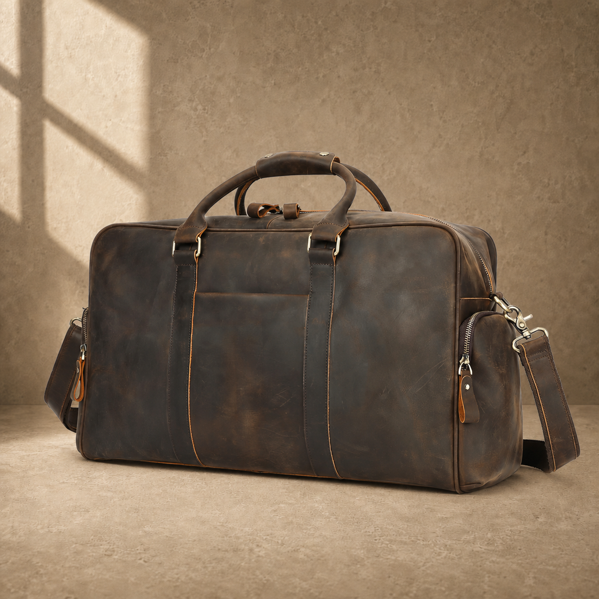 Deep coffee leather weekender duffel, front three-quarter hero view