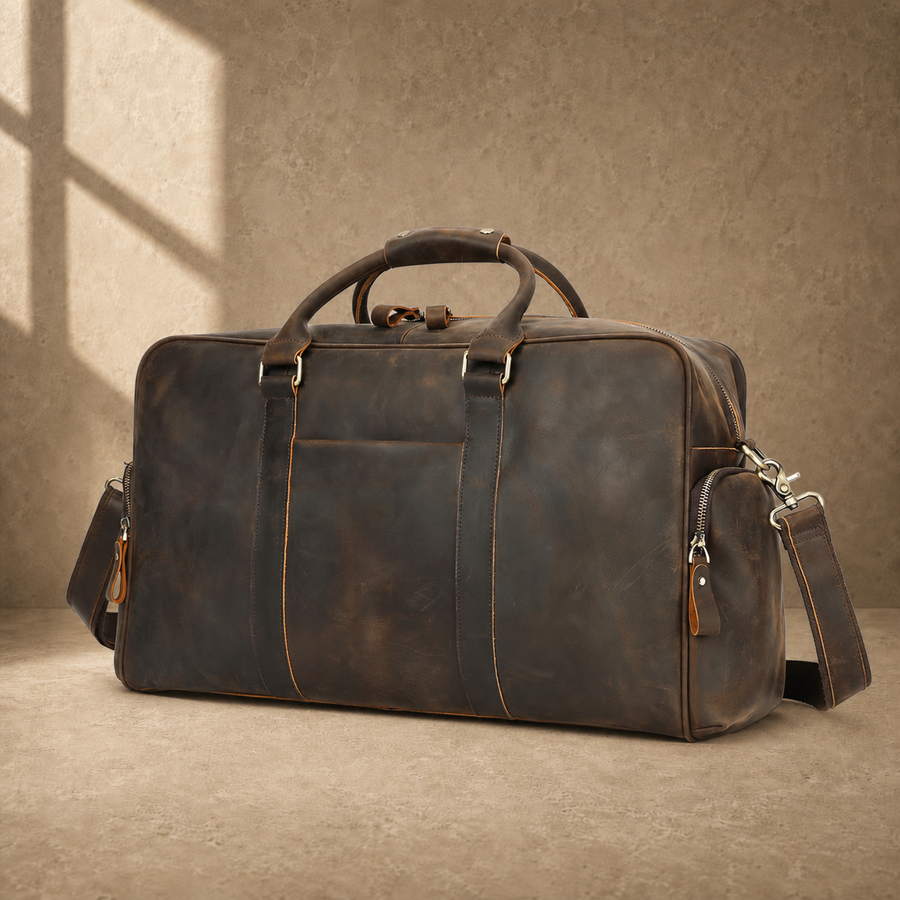 Deep coffee leather weekender duffel, front three-quarter hero view