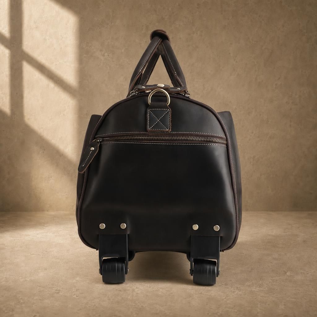 Side view of brown rolling garment bag with wheels and zip pocket