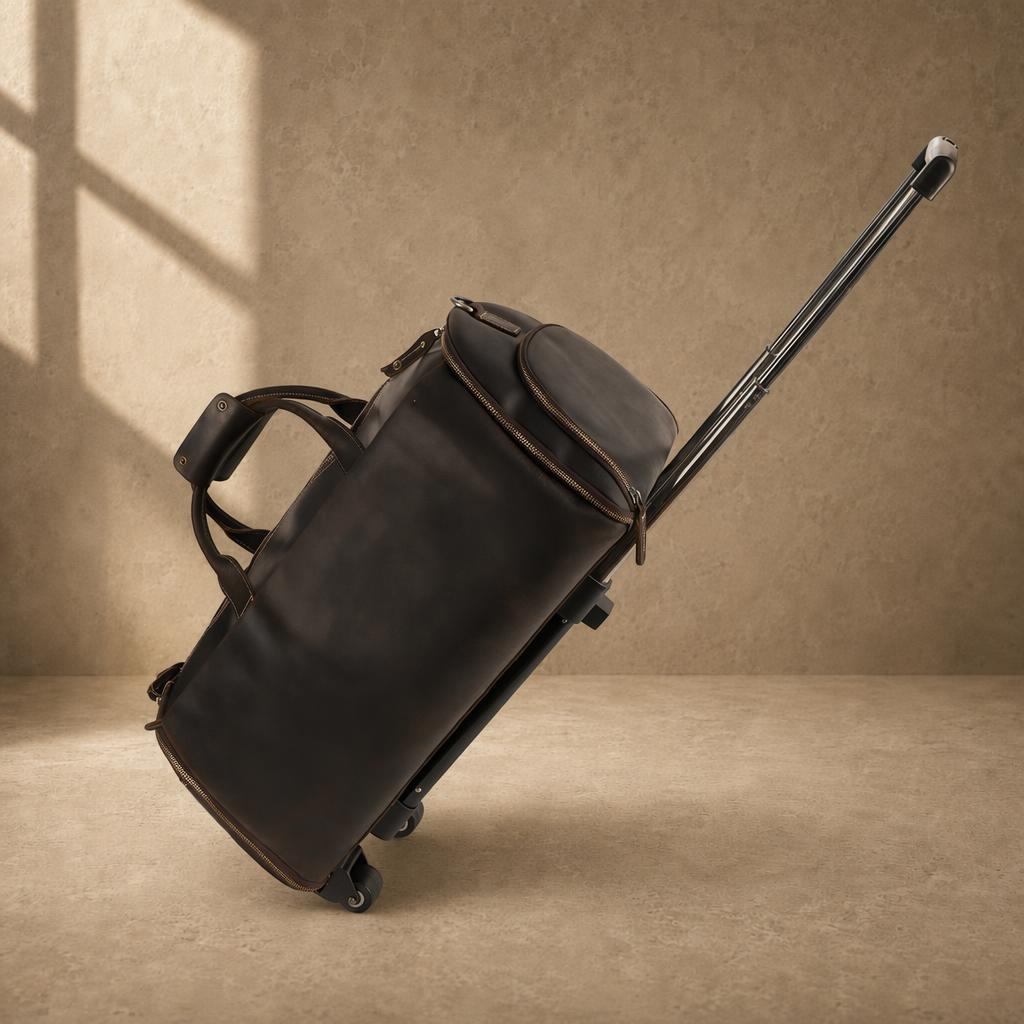 Dark brown cowhide rolling garment bag with telescoping trolley handle extended