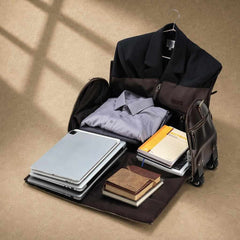 Fold-out brown garment weekender holding suit, clothing, laptop and travel essentials