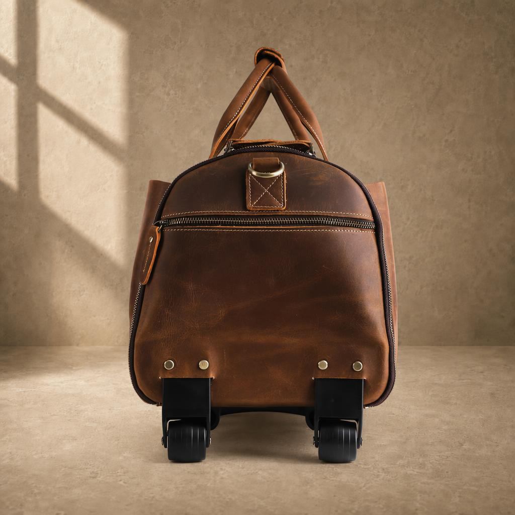 Rear side view of cognac rolling garment bag showing integrated wheels