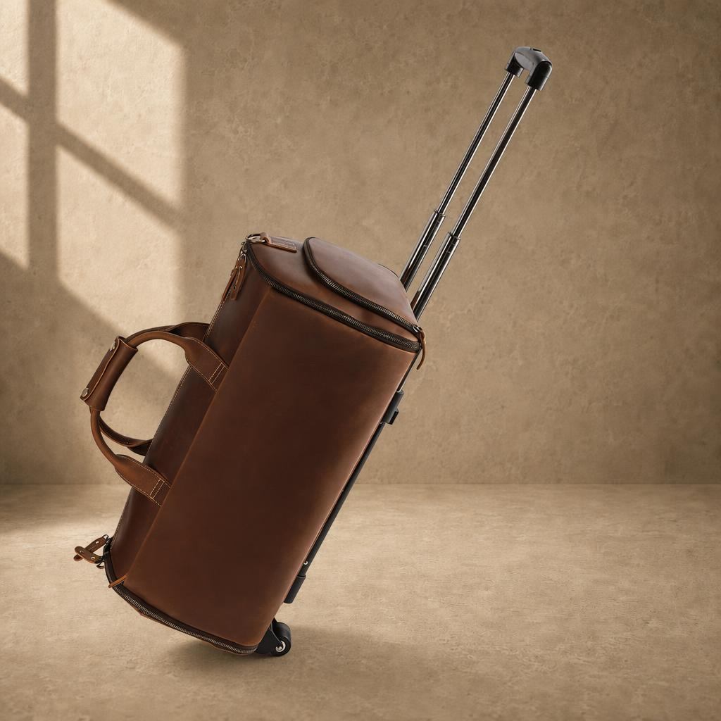 Cognac cowhide rolling travel bag in motion with telescoping handle