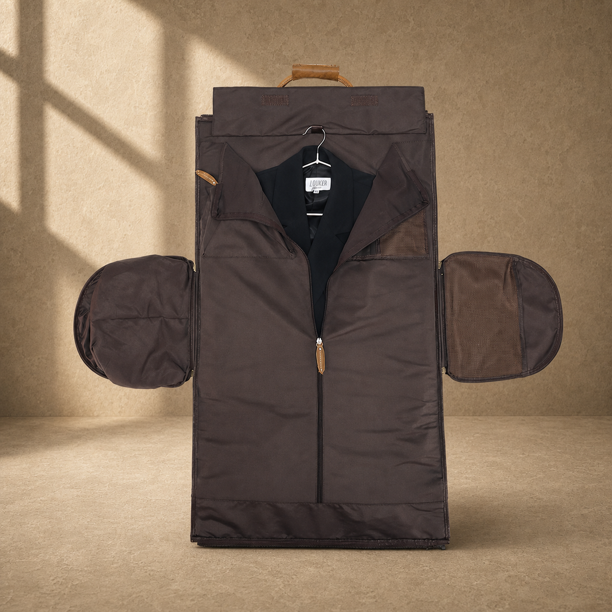 Fold-out cognac garment weekender holding a suit jacket