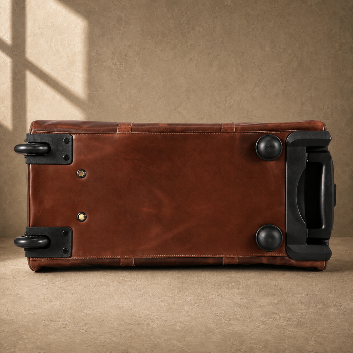 Base view of coffee rolling duffel showing wheels and protective feet