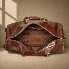 Open coffee leather rolling duffel showing empty lined interior