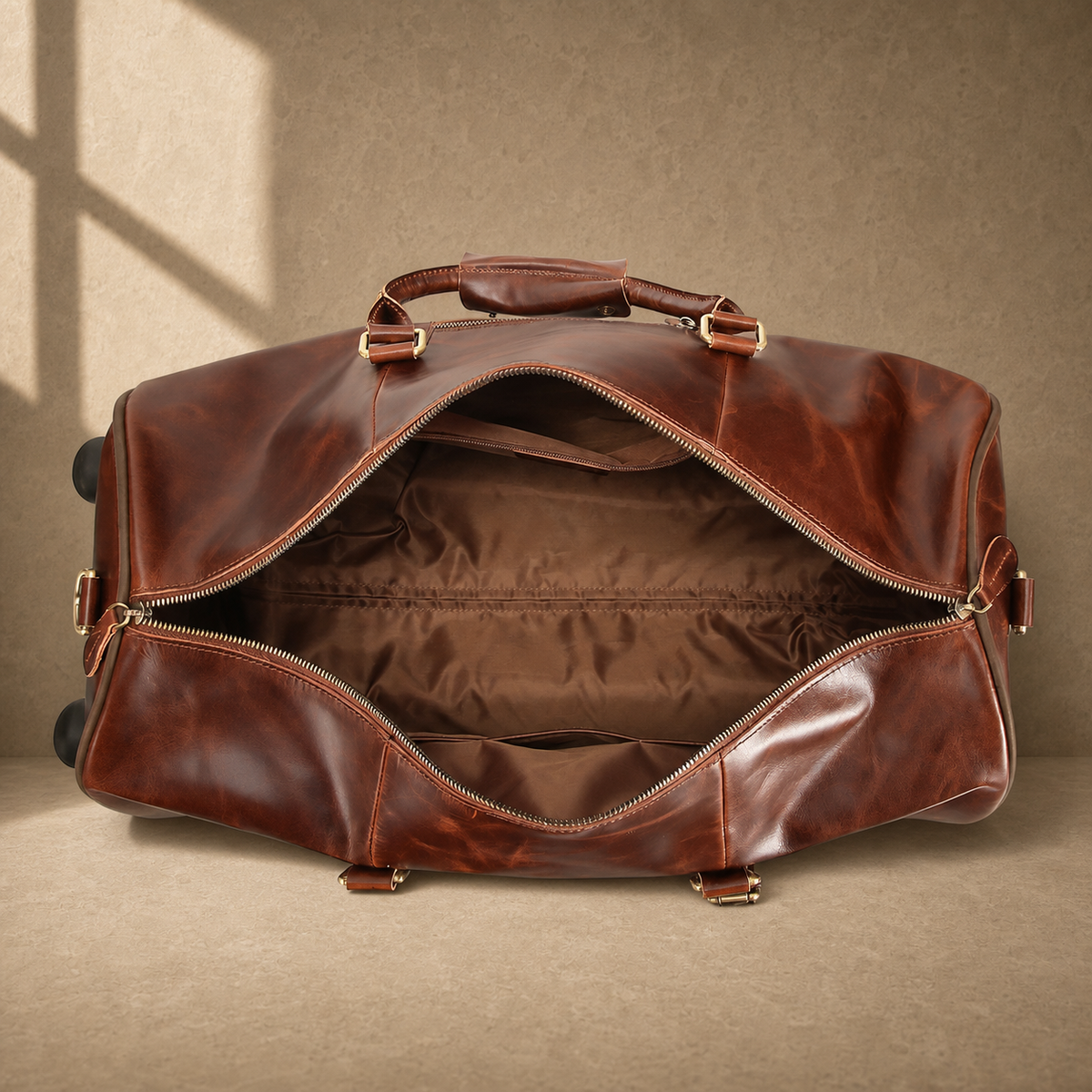 Open coffee leather rolling duffel showing empty lined interior