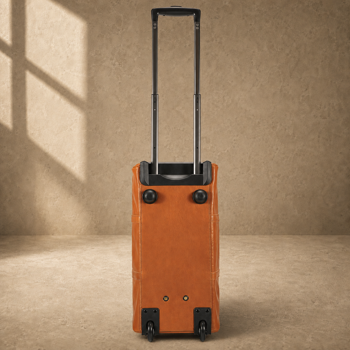 End view of cognac rolling duffel showing four wheels and trolley handle
