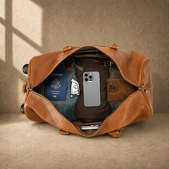 Packed cognac leather rolling duffel showing travel capacity
