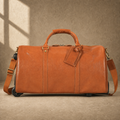 Cognac leather rolling travel duffel, front view with shoulder strap