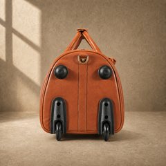 Wheel-end view of cognac leather rolling travel duffel