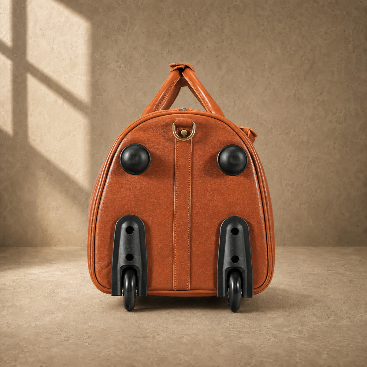 Wheel-end view of cognac leather rolling travel duffel
