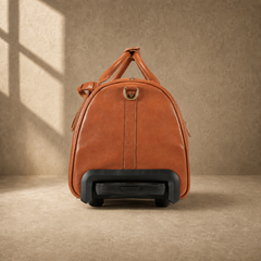 Handle-end view of cognac leather rolling weekender