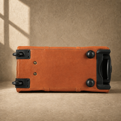 Base view of cognac rolling duffel showing wheels and protective feet