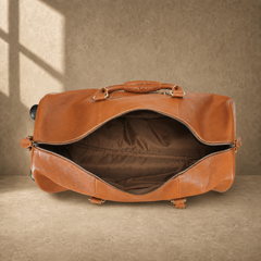 Open cognac leather rolling duffel showing empty lined interior