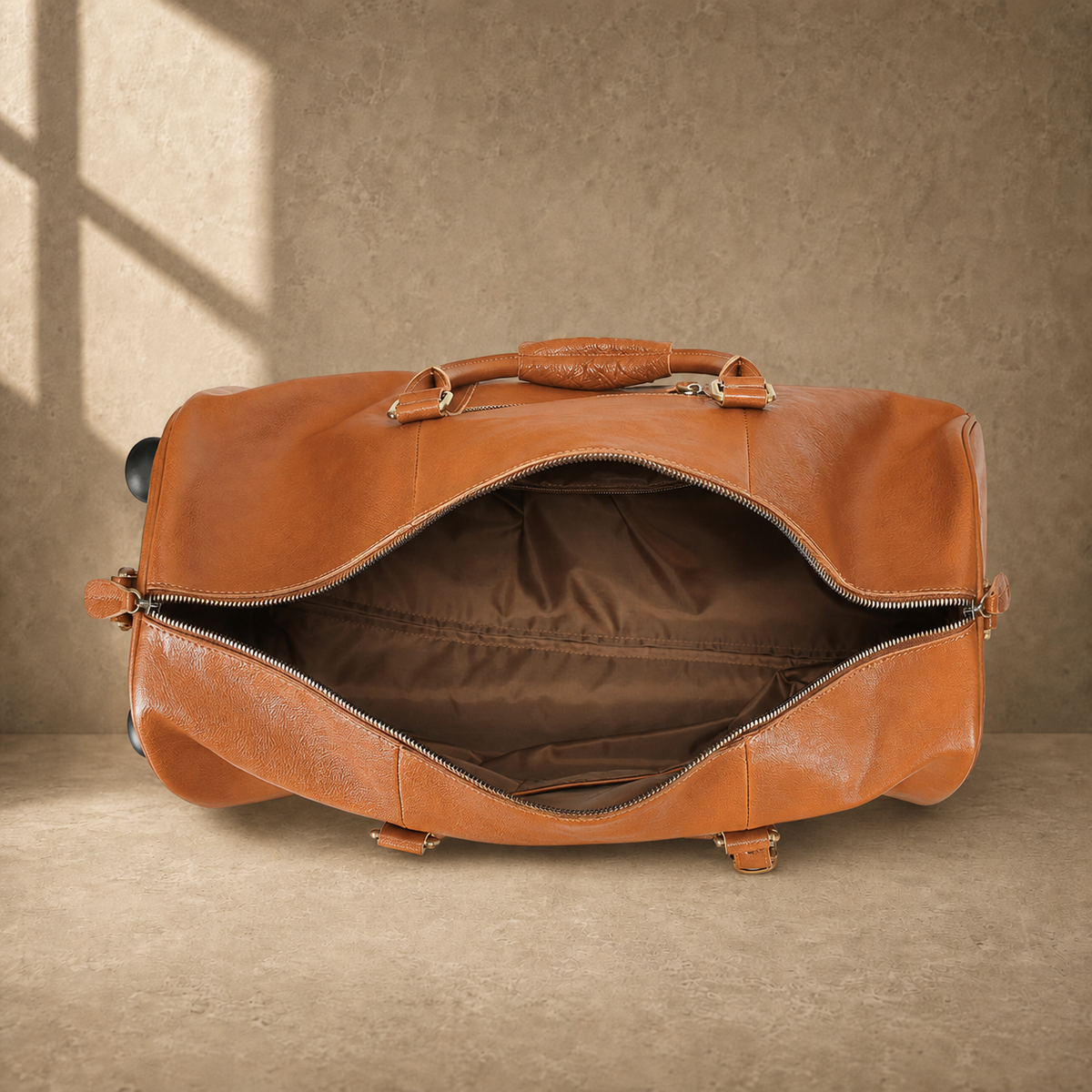 Open cognac leather rolling duffel showing empty lined interior