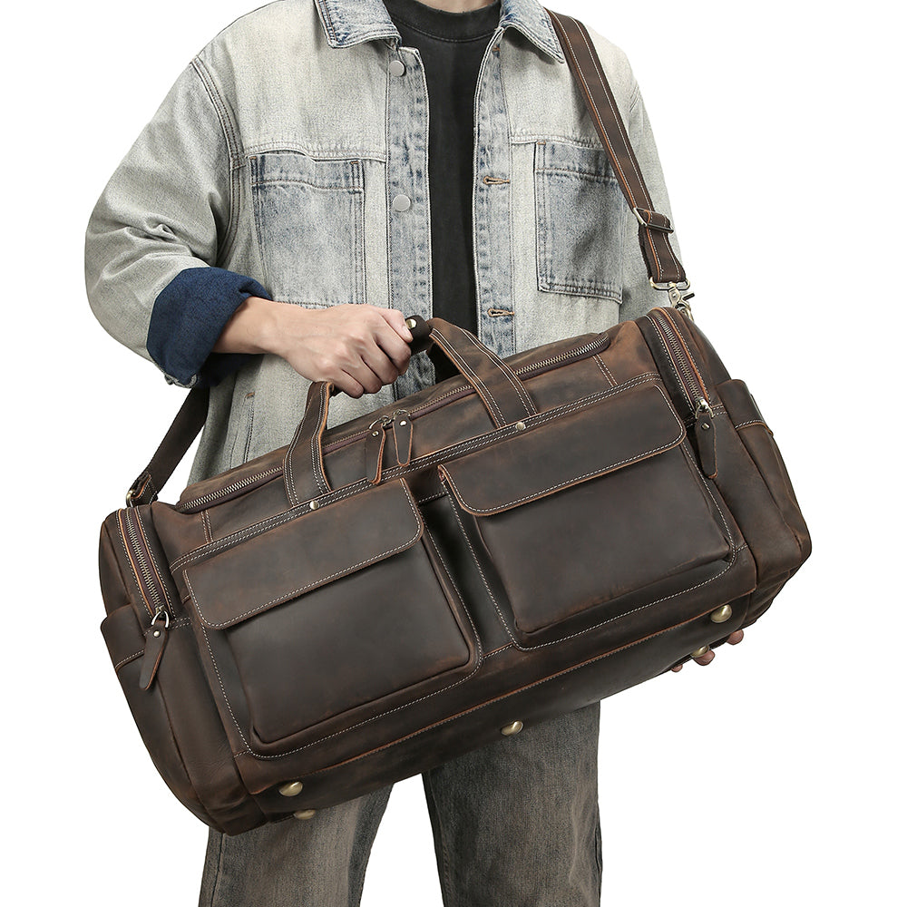Traveler carrying the coffee leather weekender by its handles