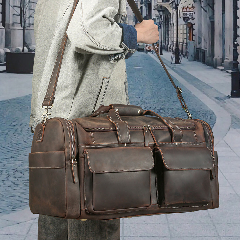 Coffee leather multi-pocket weekender carried on an urban street