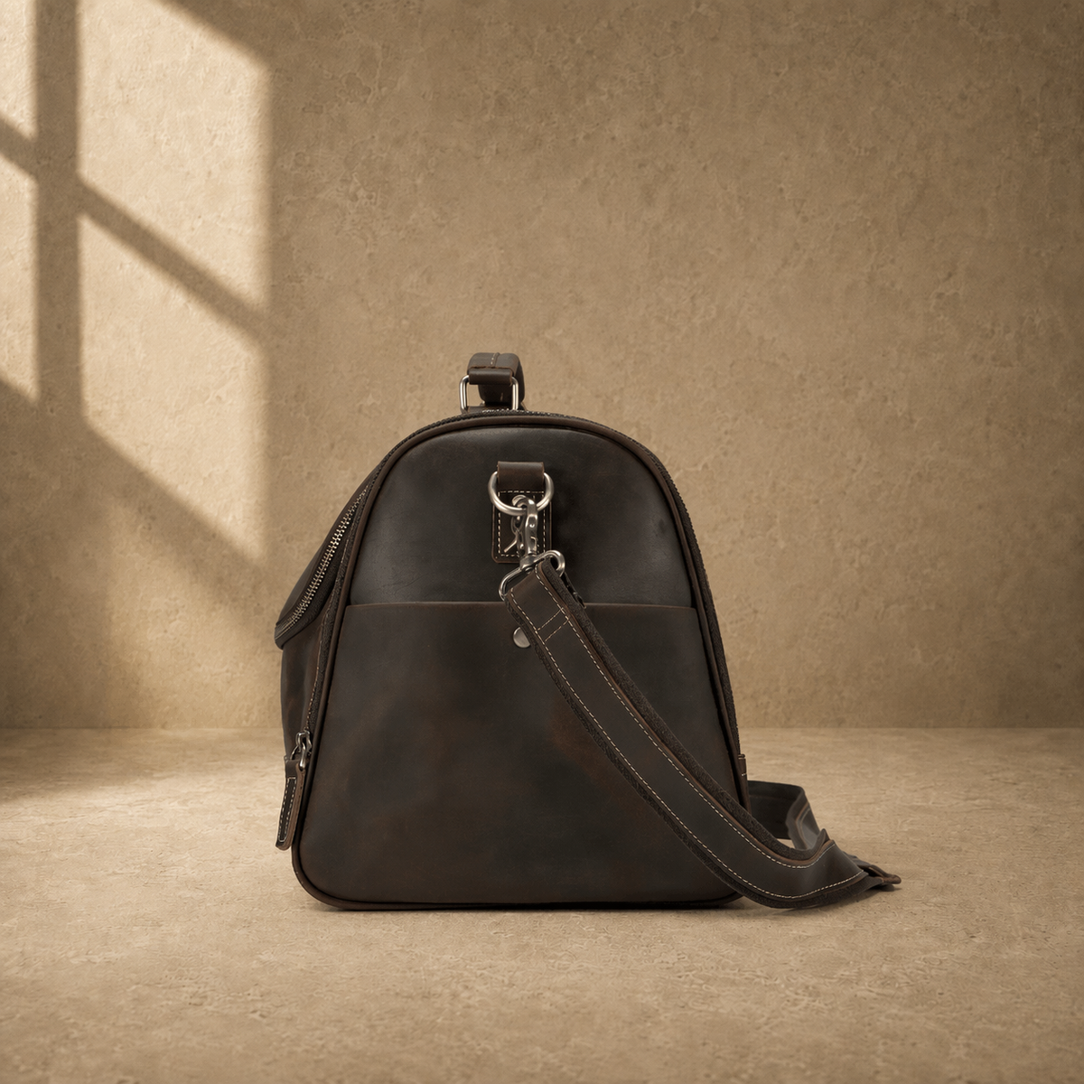 Brown leather business travel duffel, side profile