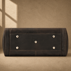 Brown leather business travel duffel with protective metal feet