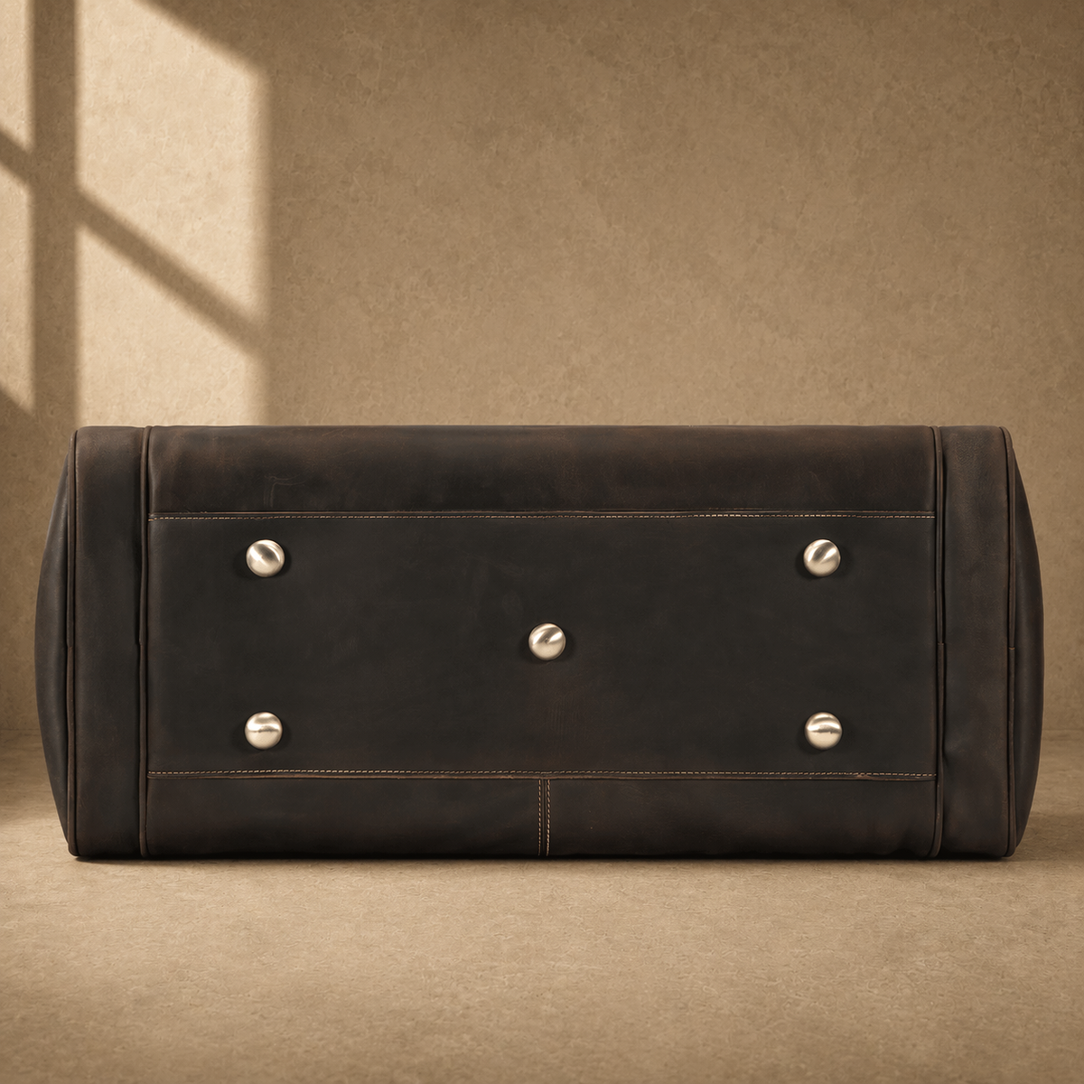 Brown leather business travel duffel with protective metal feet
