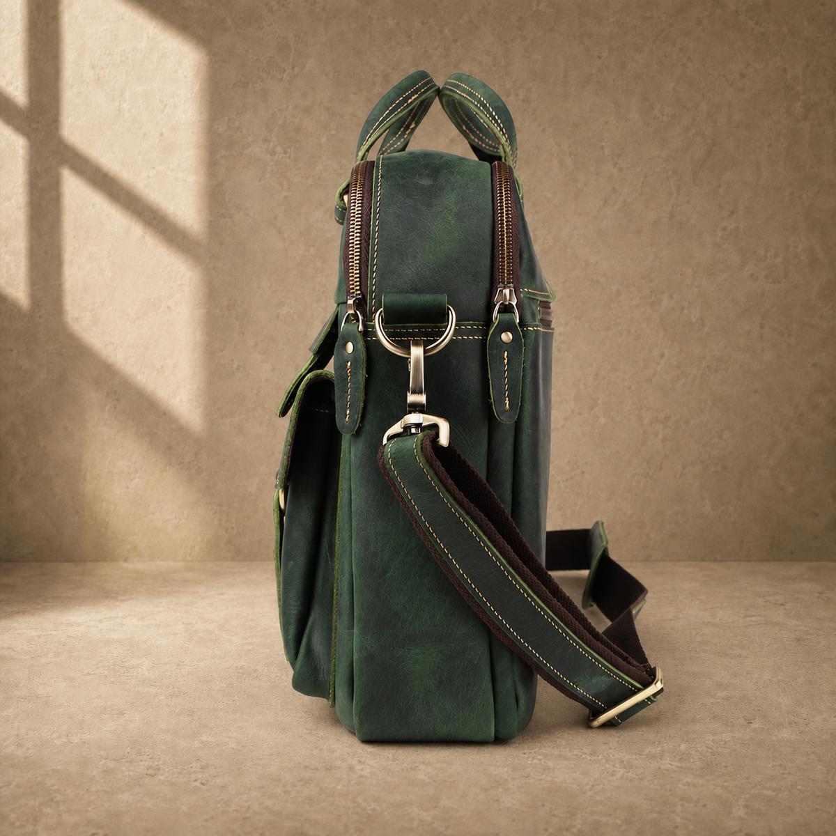 Vintage green leather work briefcase, side profile with strap
