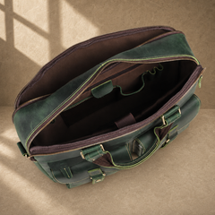 Vintage green leather work briefcase, open empty compartments