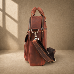 Reddish brown leather work briefcase, side profile with strap