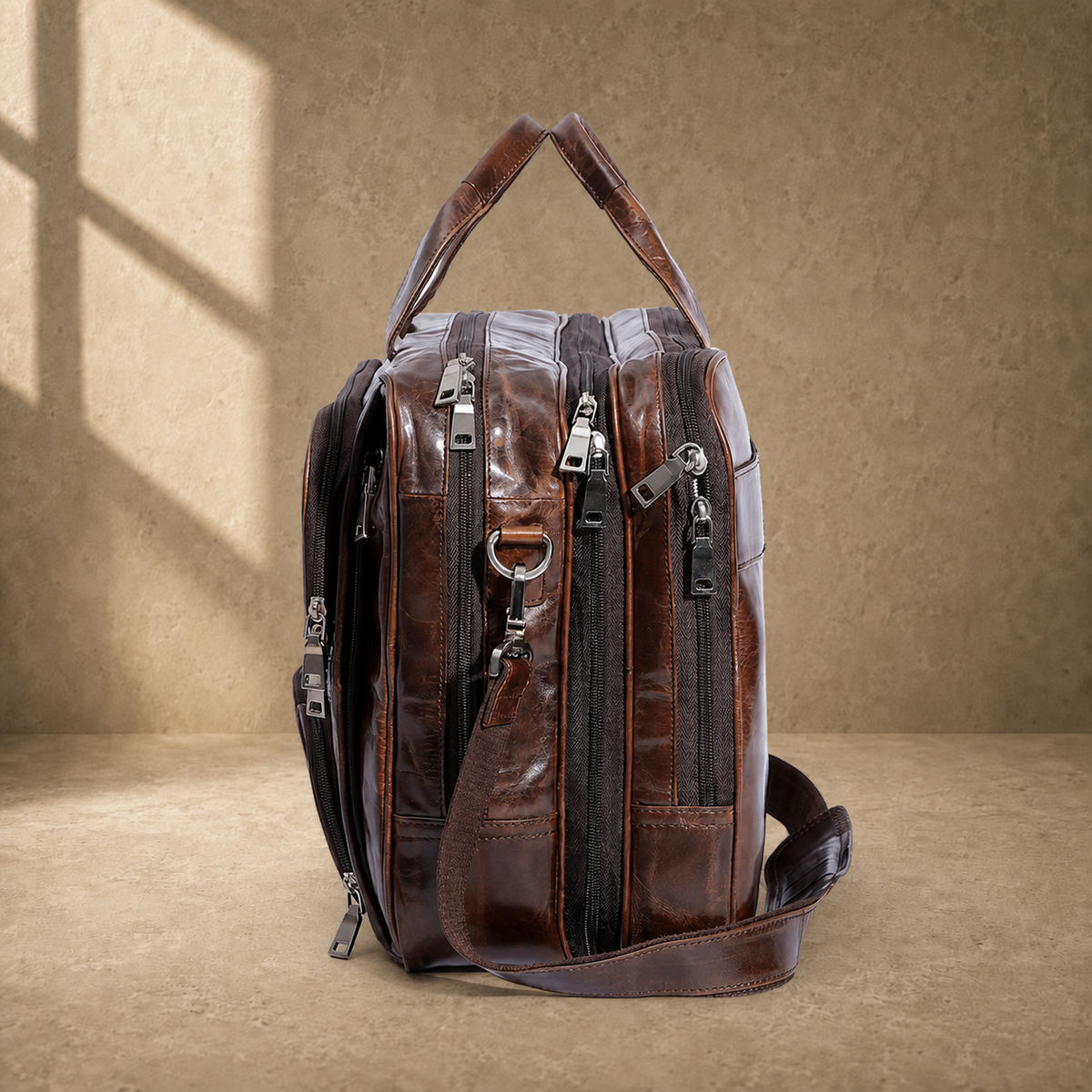 Brown cowhide multi-pocket briefcase side profile with shoulder strap