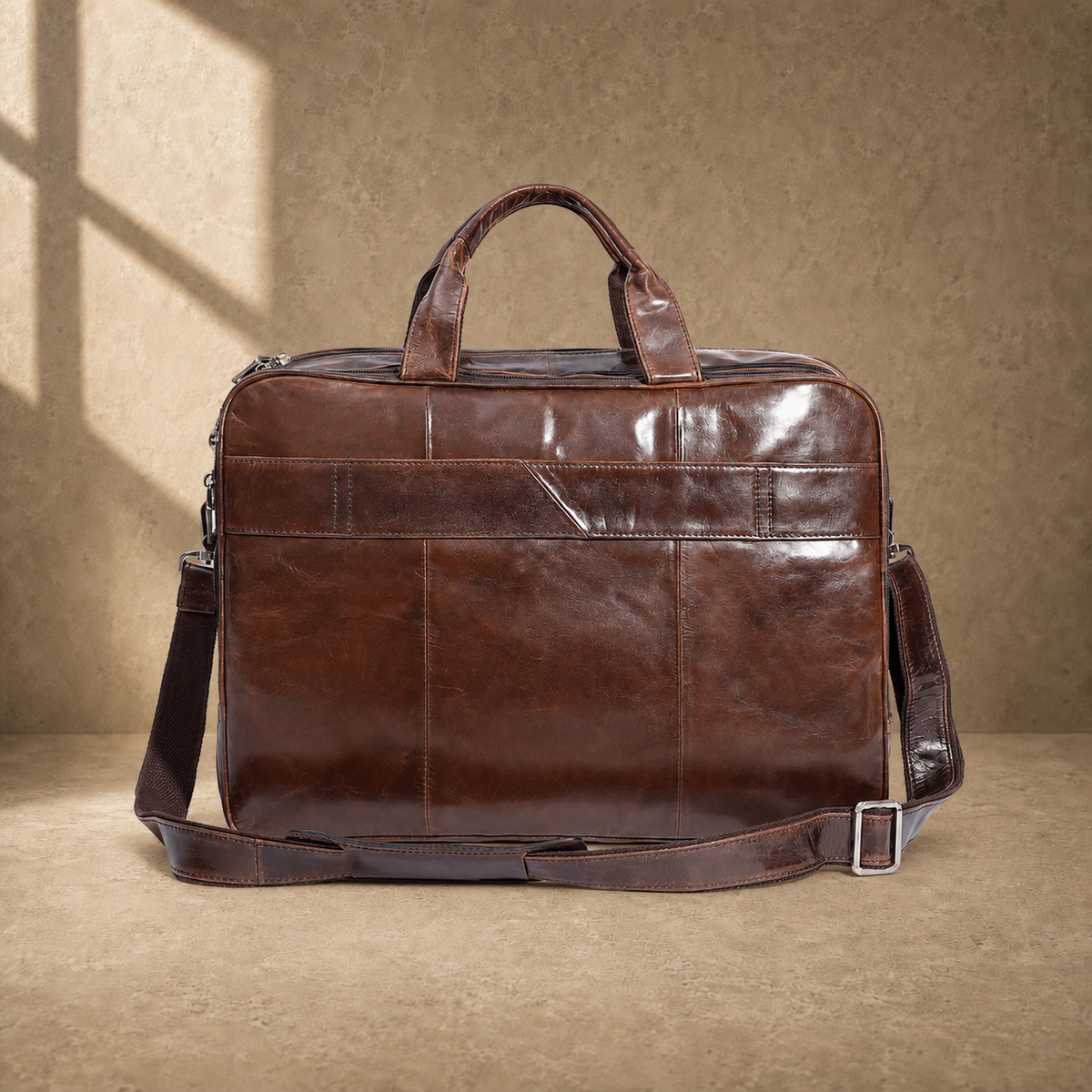Brown cowhide multi-pocket briefcase rear luggage strap view