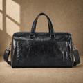 Black textured refined travel duffel with removable shoulder strap, front view