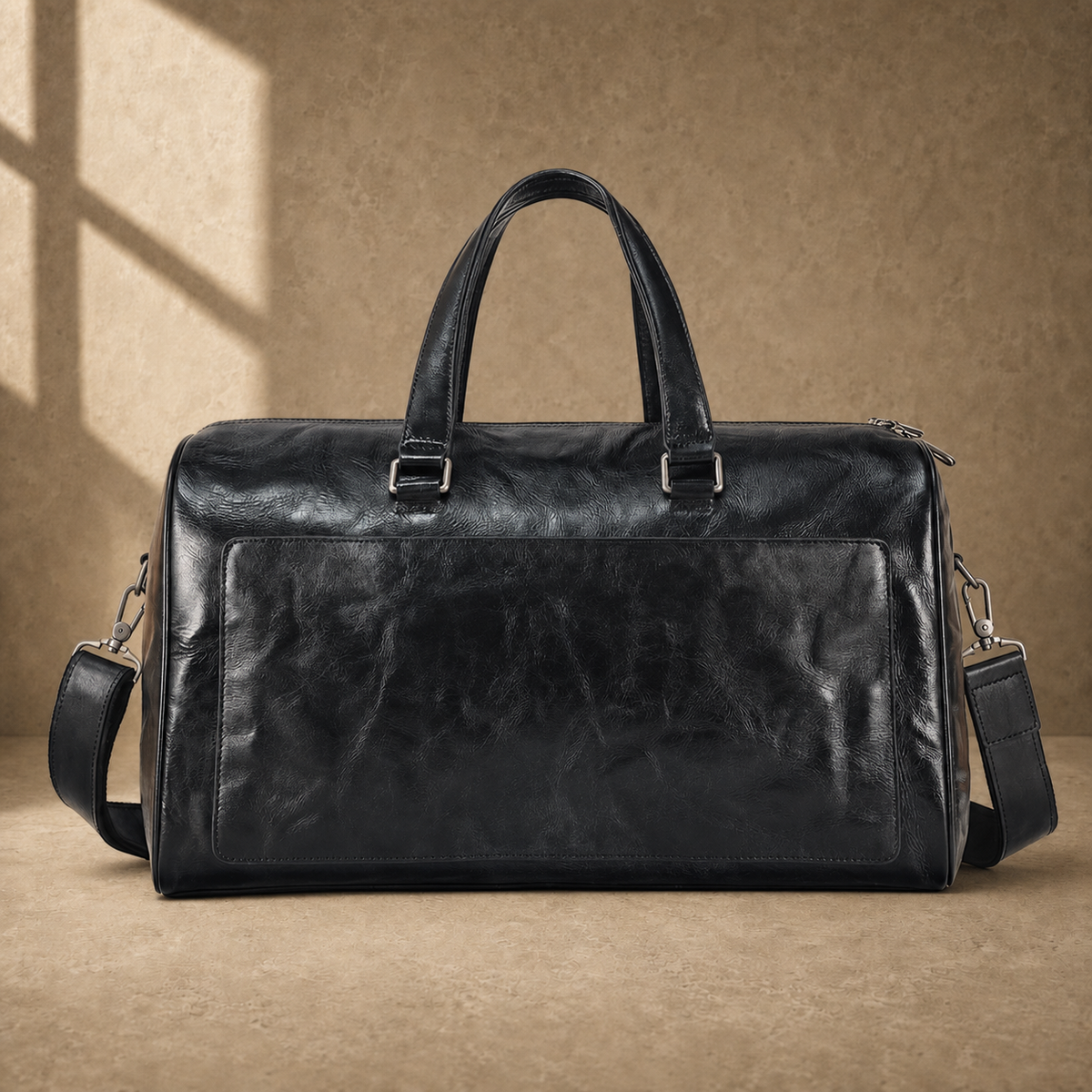 Black textured refined travel duffel with removable shoulder strap, front view