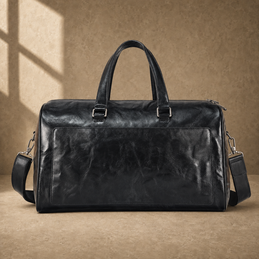 Black textured refined travel duffel with removable shoulder strap, front view