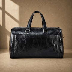 Black textured refined travel duffel without shoulder strap, front view