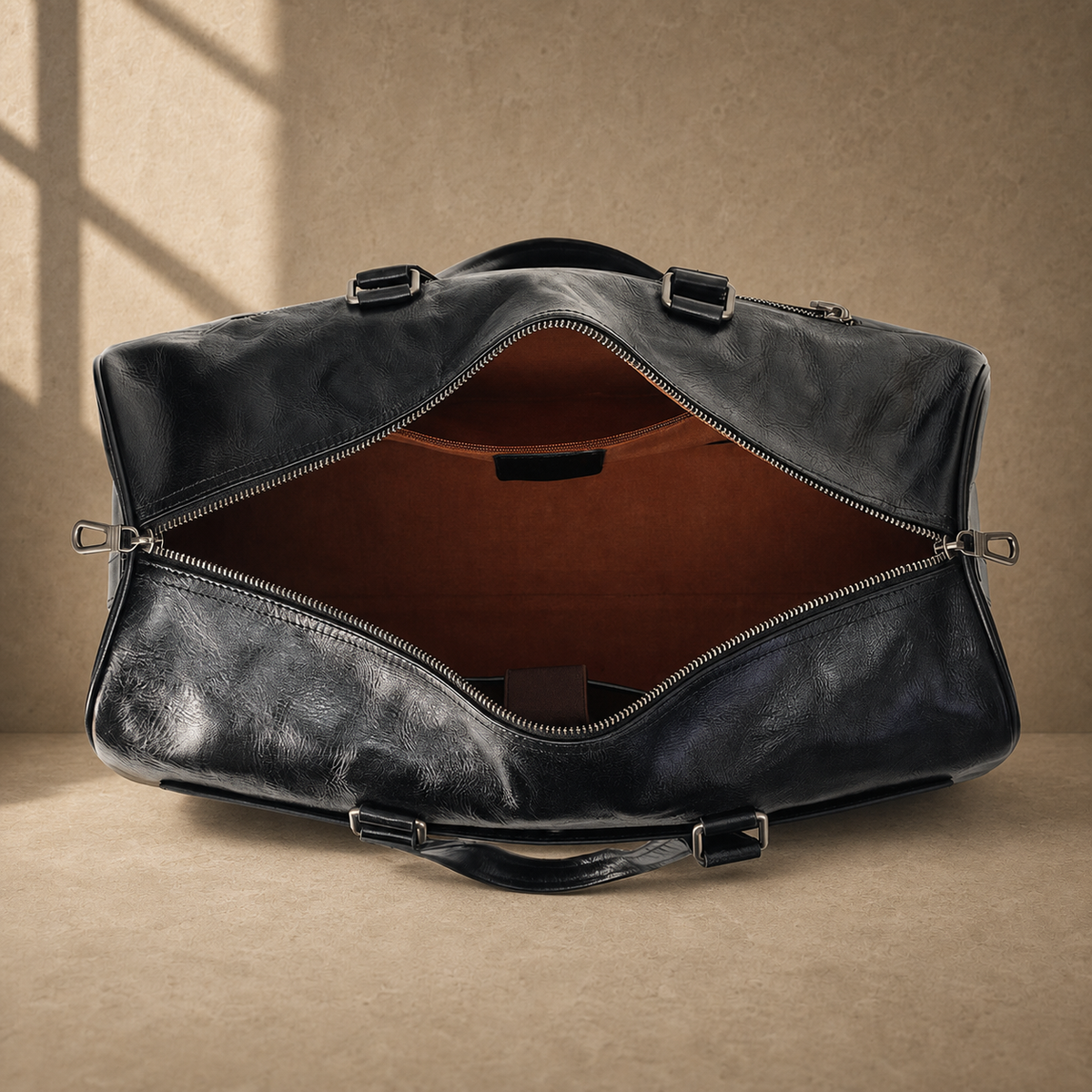 Black textured refined travel duffel showing empty brown-lined compartment