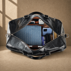 Black textured refined travel duffel showing laptop and packed capacity