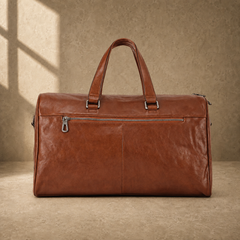 Dark-brown refined travel duffel with rear zipper pocket and luggage sleeve