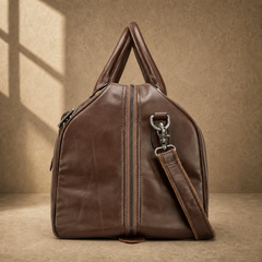 Brown classic overnighter travel bag side view with strap hardware