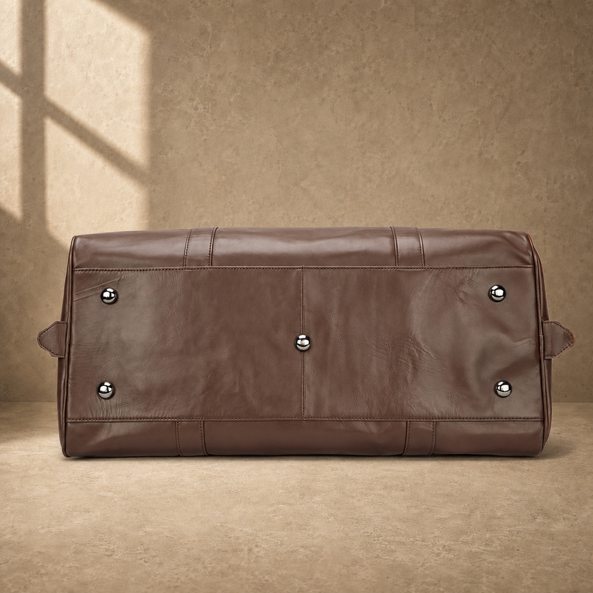 Brown classic overnighter travel bag base with metal feet