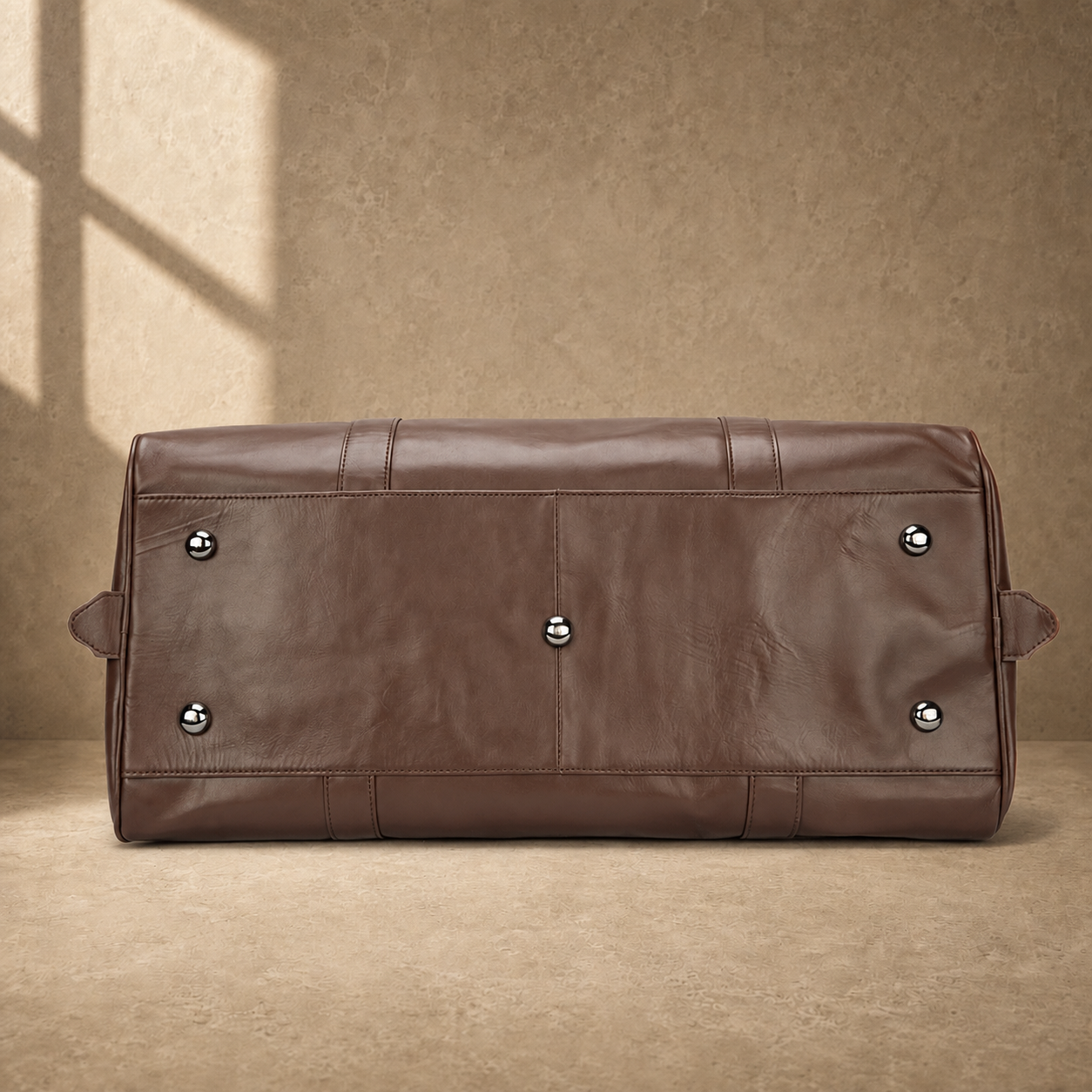 Brown classic overnighter travel bag base with metal feet