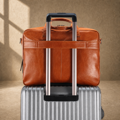 Light brown cowhide laptop briefcase rear luggage sleeve on suitcase